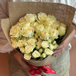 Load image into Gallery viewer, Bouquet of yellow roses held by a person against a plain background
